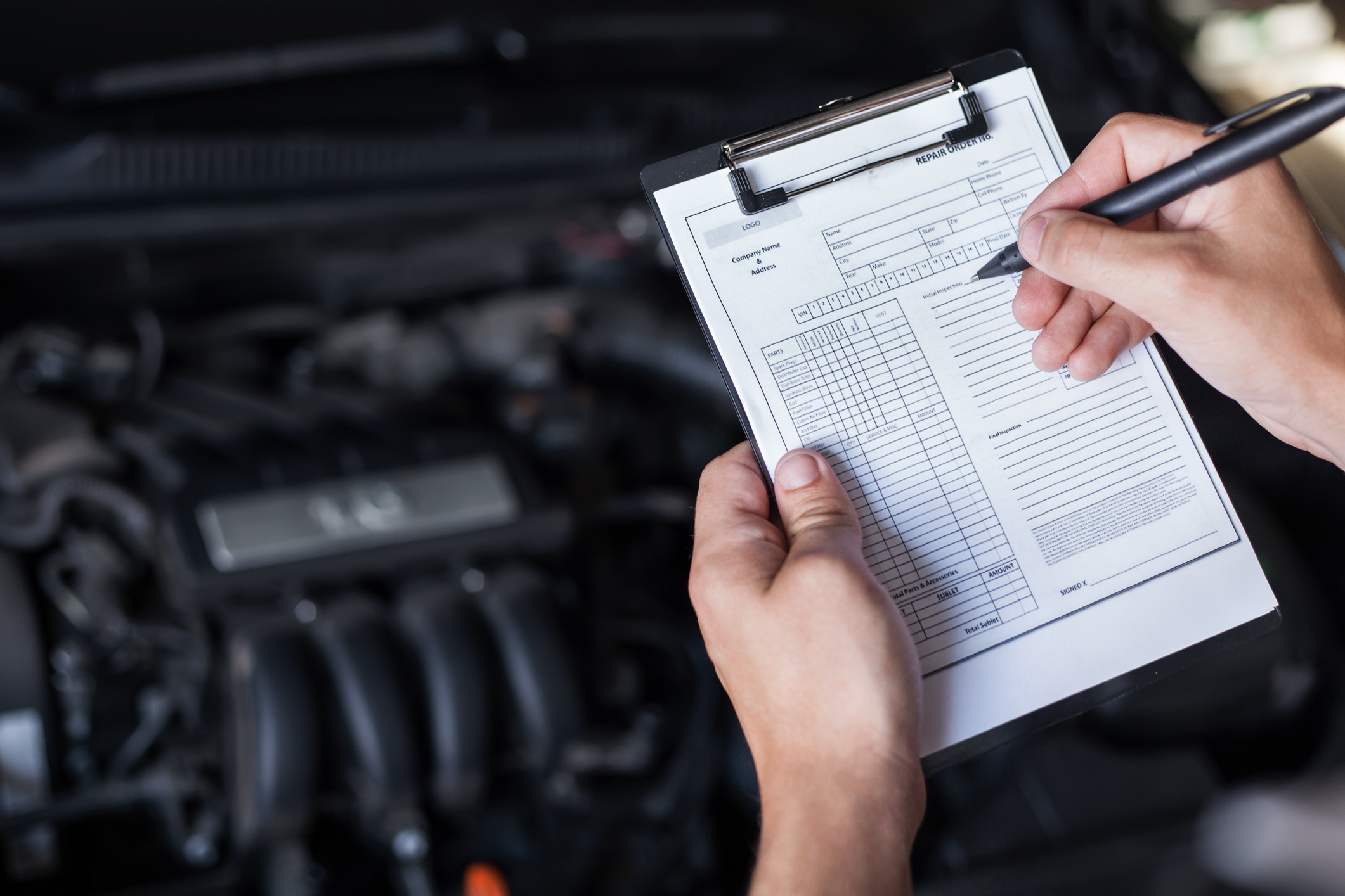 mechanic repairman inspecting car